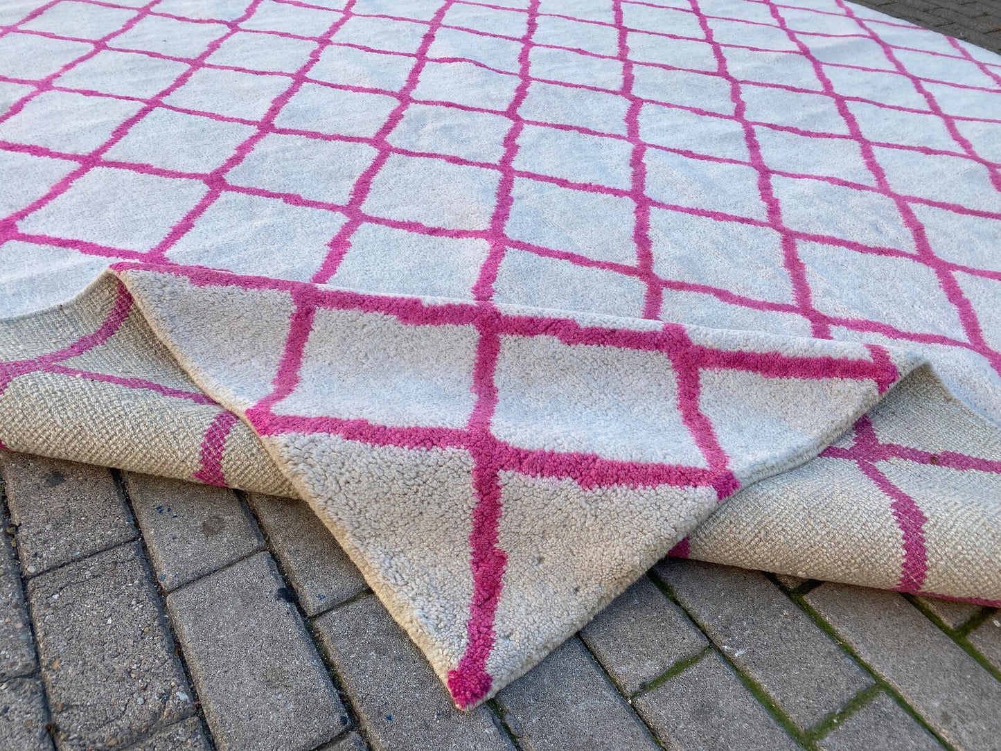 Moroccan Berber pink and white rug.