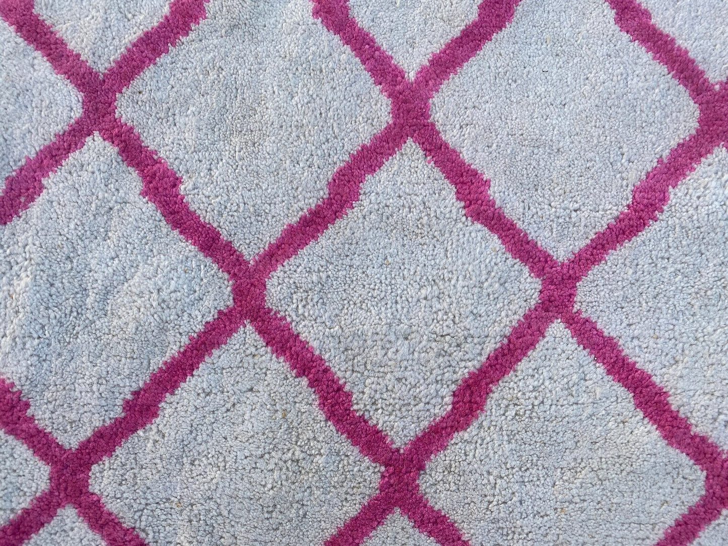 Moroccan Berber pink and white rug.