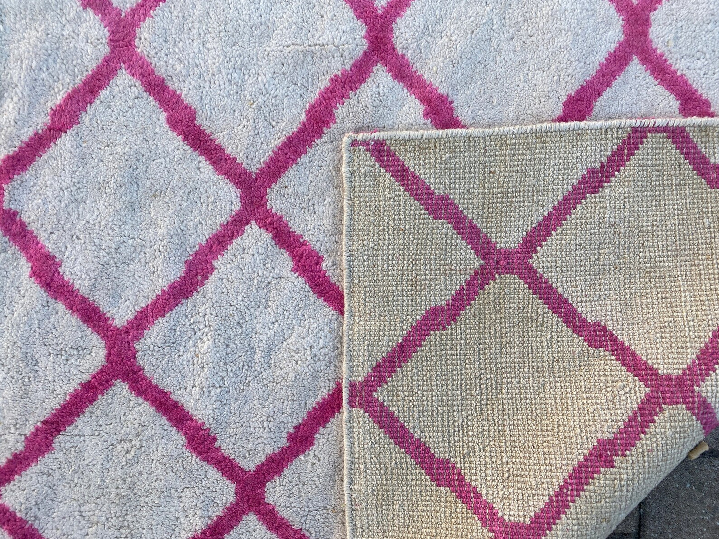 Moroccan Berber pink and white rug.